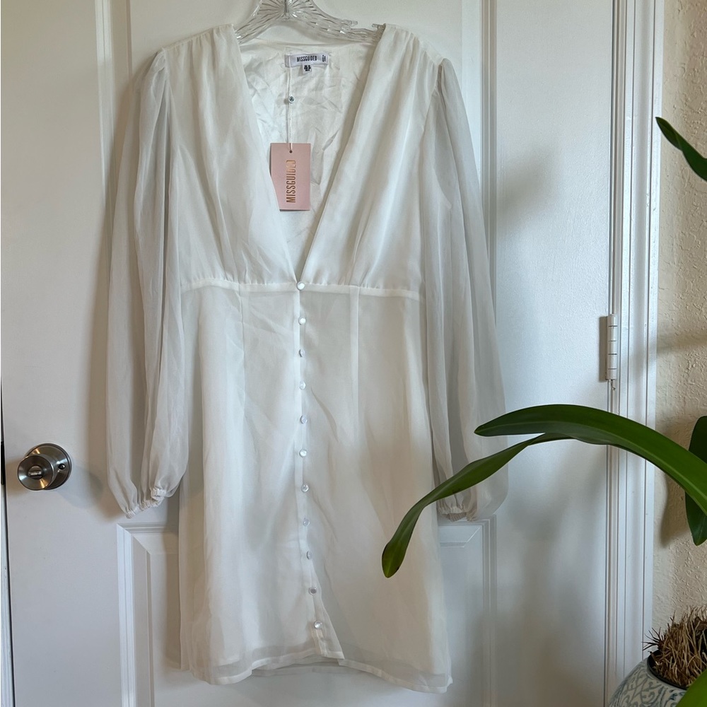 Deep plunging whimsical dress with peasant sleeve and pearlescent button detail